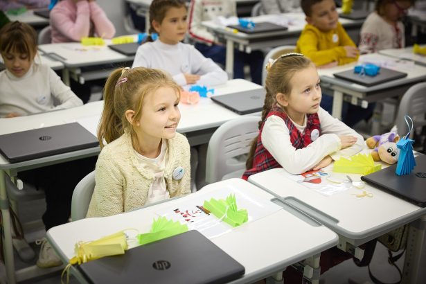 Students learning in a phone-free classroom, focused on their lesson