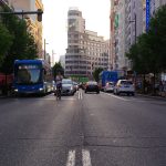 Traffic and pedestrians on Gran Via in Madrid on a summer day