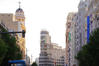 Traffic and pedestrians on Gran Via in Madrid on a summer day