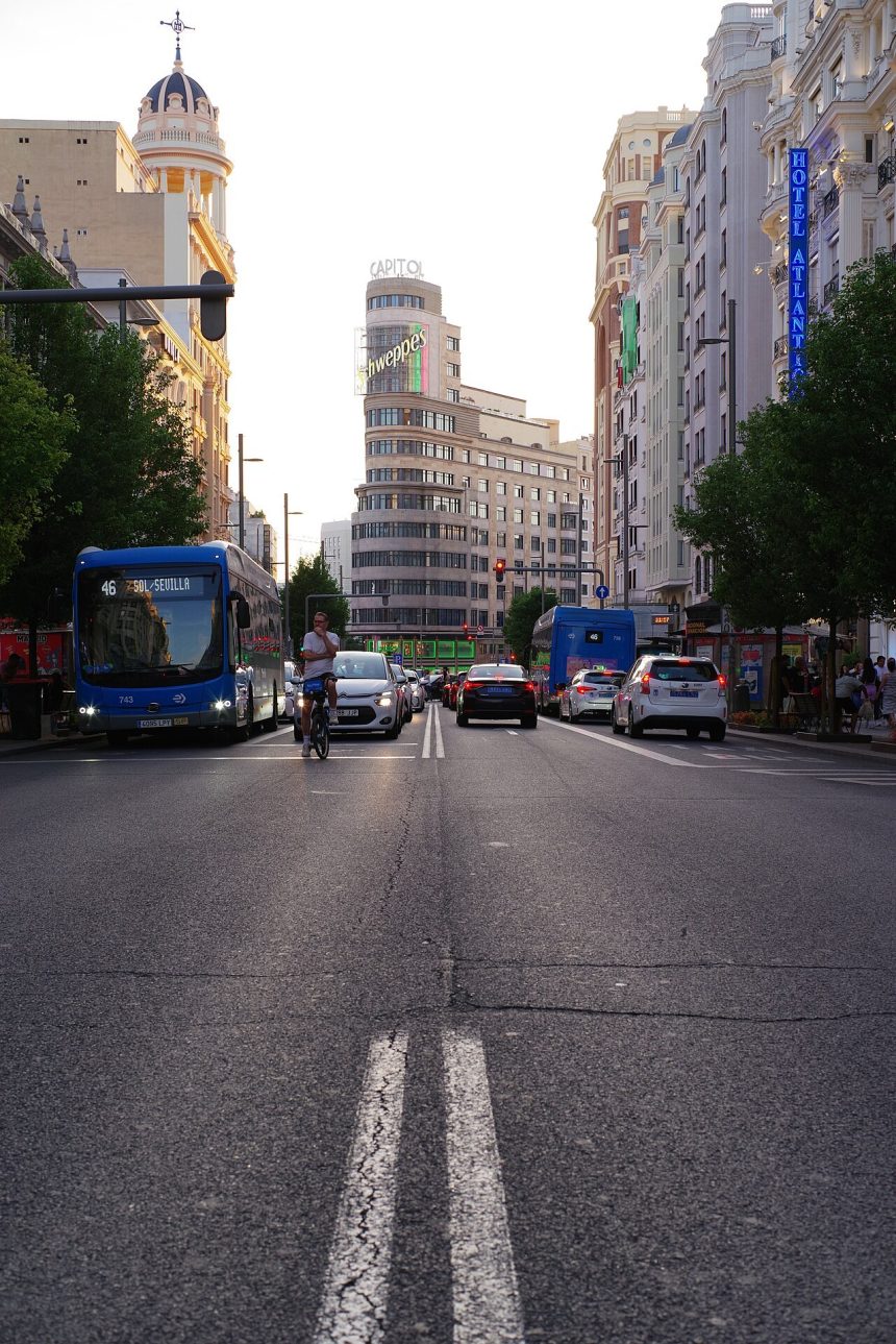 Traffic and pedestrians on Gran Via in Madrid on a summer day