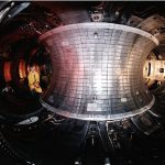 The glowing interior of a tokamak fusion reactor during an experiment