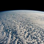 A satellite view of storm systems over Earth, the kind of data now feeding AI weather forecasting models.