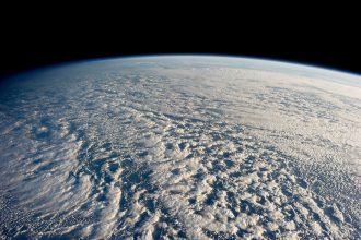 A satellite view of storm systems over Earth, the kind of data now feeding AI weather forecasting models.