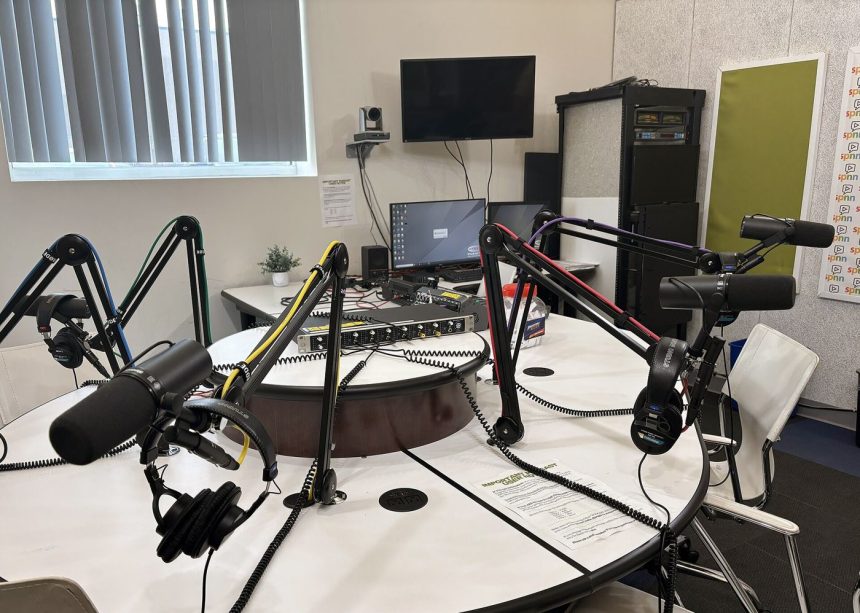A podcast host recording in a studio with professional microphones
